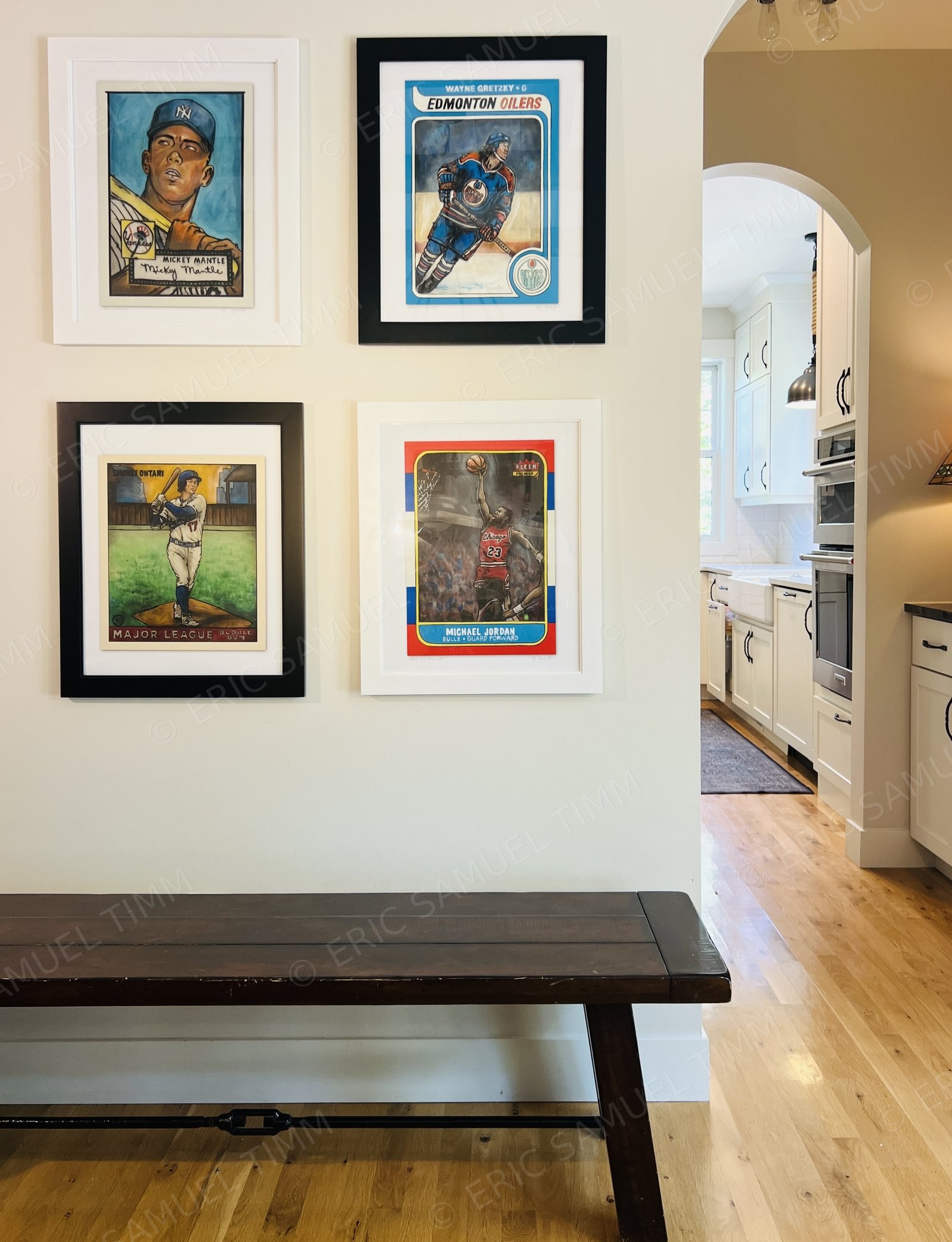 Four framed originals — Mickey Mantle, Wayne Gretzky, Shohei Ohtani, and Michael Jordan — installed together on a wall in a client's home